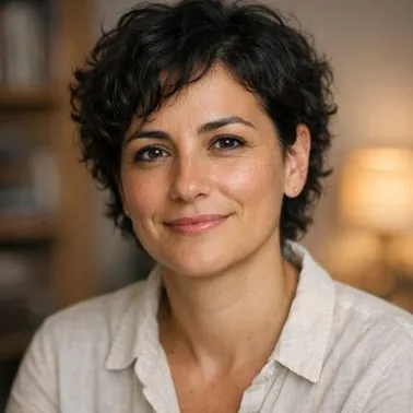 Woman in her late 30s, short dark curly hair, relaxed expression, olive skin